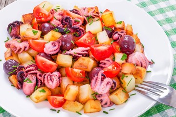 Potato salad with pickled octopus, close-up