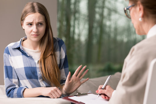 Introvert girl refusing to talk with specialist