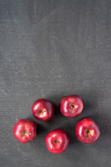 Five apples on painted board