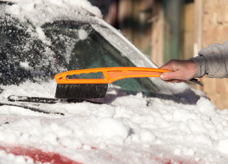 scraping snow from car winter