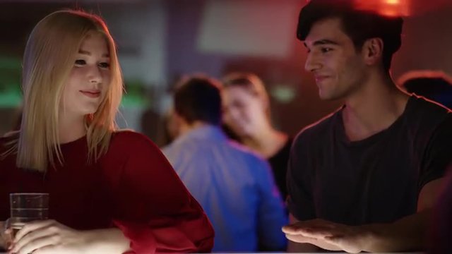 two girls at bar in club meet good looking guy who introduces himself