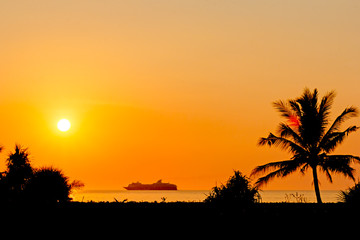 Sunset at the beach with cruise ship on back 