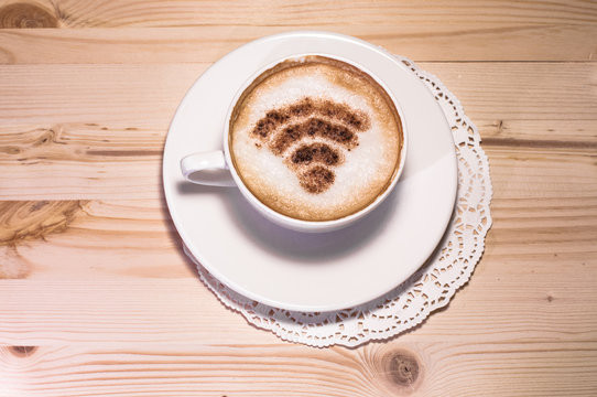 Wifi logo made of cinnamon on cappuccino