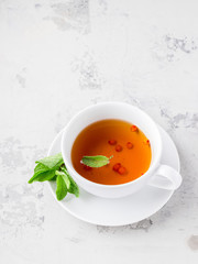 Cup of tea with mint and berries