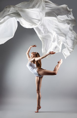 beautiful young girl dancing. Flowing fabric.