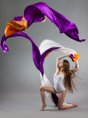 beautiful young girl dancing. Flowing fabric.