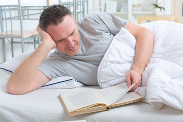 Fototapeta premium Reading book in bed