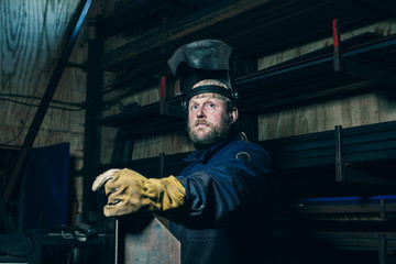 Portrait of welder with beard in workplace