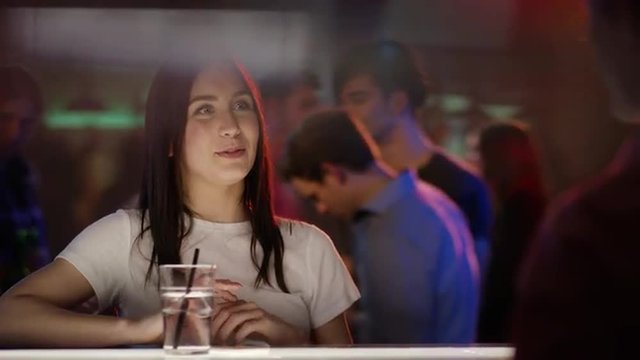 Woman ordering drink at bar