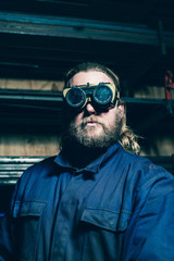Portrait of bearded welder with safety glasses