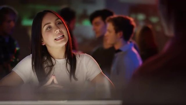 Beautiful woman is ordering a drink at bar