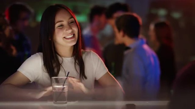 Young woman flirting with barkeeper