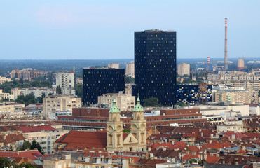 Naklejka premium Basilica of the Sacred Heart of Jesus and the new metal and black glass office buildings in the center of the city in the background in Zagreb, Croatia