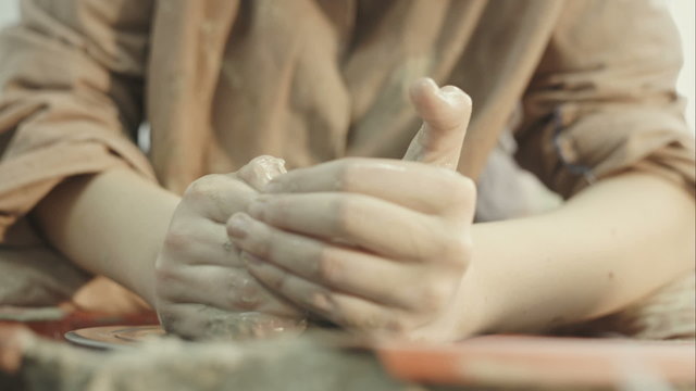 Hands working on pottery wheel. RAW video record.