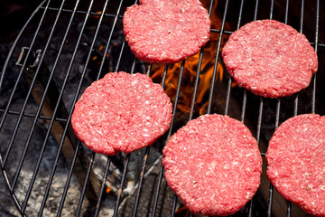 Hamburgers with fresh sliced vegtables and fries.