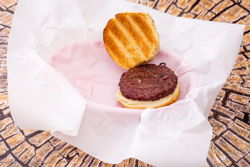 Hamburgers with fresh sliced vegtables and fries.