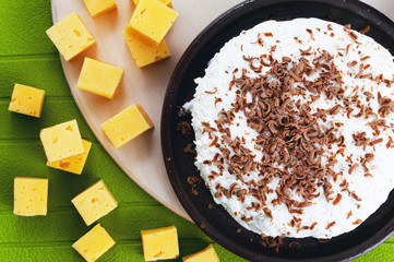 Cottage cheese and cheese on a green background