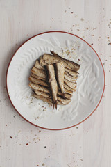 Canned sprats on dish