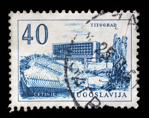 Obraz premium Stamp printed in Yugoslavia, shows Titograd (Podgorica) Hotel and Open-Air Theater in Cetinje, circa 1958