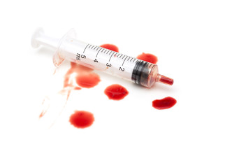 syringe and red blood on white background