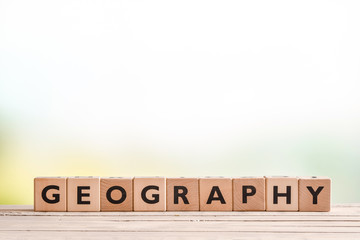 Geography lesson sign on a wooden desk