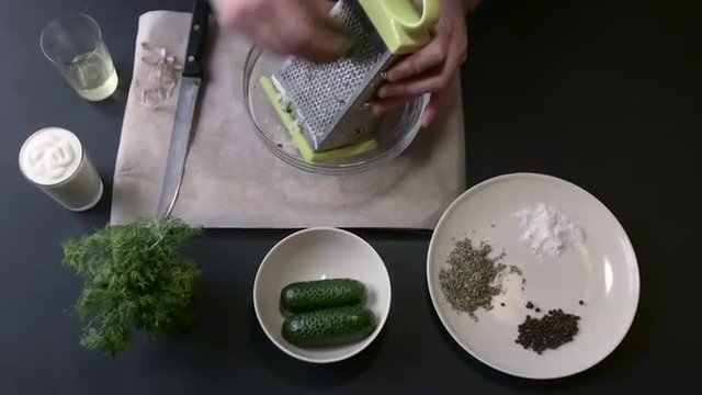 Male Cook Grate the Cucumber