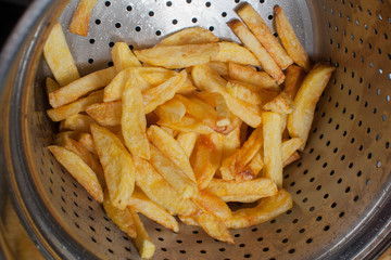 a lot of delicious french fries cooked at home on a white background