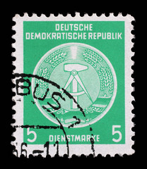 Stamp printed in GDR (German Democratic Republic - East Germany) shows DDR national coat of arms...