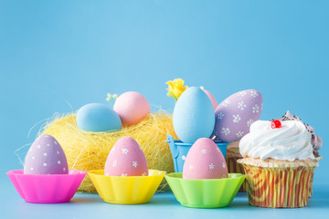 decoration with easter eggs nest on blue background