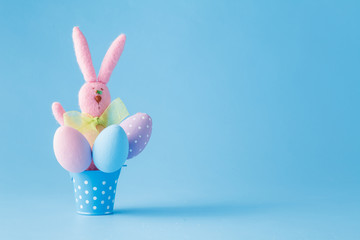 Easter eggs with basket on a blue background
