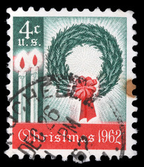 America's first Christmas postage stamp shows a wreath and candles. It was well received and...