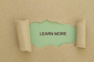 Learn more message written under torn paper.