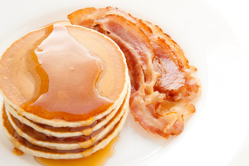 Pancakes with maple syrup and bacon. Breakfast.