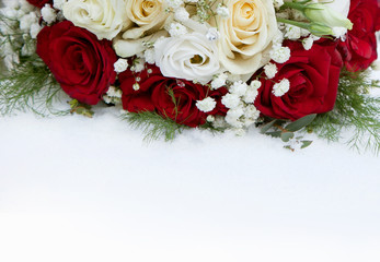 Bouquet of roses lying in the snow