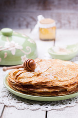 Stack of pancakes with honey and butter.Carnival,a traditional Russian holiday.selective focus.