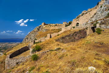 Fototapeta na wymiar Greece. Acrocorinth (the acropolis of ancienth Corinth) - fortified citadel formed on the top of monolithic rock. There is the Corinthian Gulf in the background