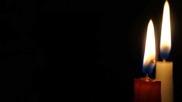 video is burning candle isolated on black