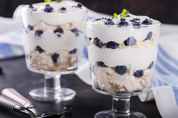 Eton mess - Blueberry with whipped cream and meringue is a Classic British summer dessert in a glass.selective focus