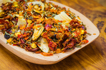 Colored spices for pasta mix on wooden spoon