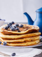 Pancake with banana , blueberries and honey.