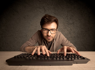 Computer geek typing on keyboard
