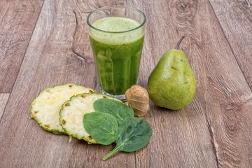 Blended smoothie with ingredients on wooden table