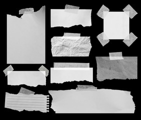 Piece of torn paper on black. Copy space