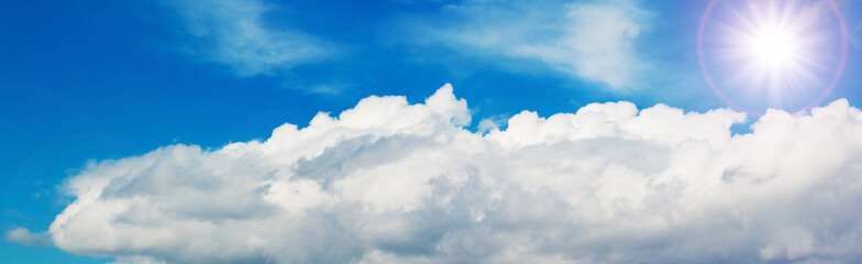 Naklejka na ściany i meble Beautiful white clouds and bright sky background. panorama.
