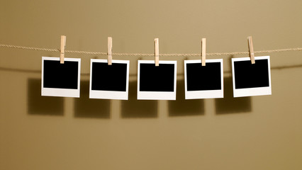 Several row line polaroid style instant photo print frame hanging on a rope string or washing line...