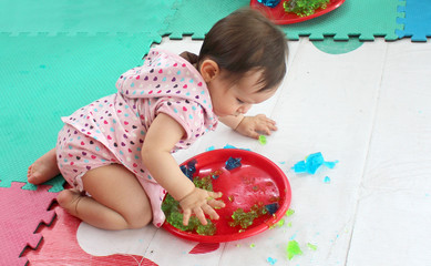 Baby playing with jelly for sensory stimulation