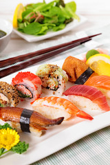 Selection of sushi plate with chopsticks. Vertical.