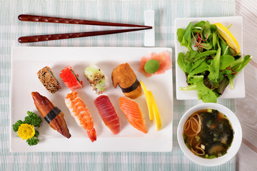 Selection of sushi plate with chopsticks on table