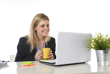 happy Caucasian blond business woman working on laptop computer at modern office desk