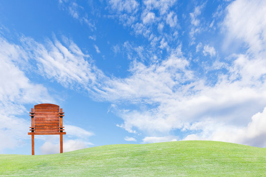 Guide Wooden Post On Green Field And Sky